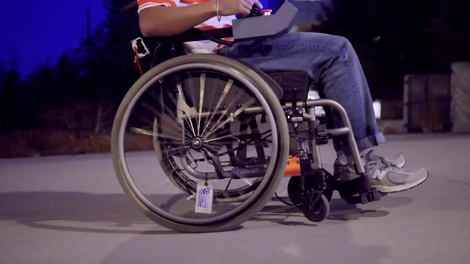 Friction Robotics prototype moving outdoors on a manual wheelchair